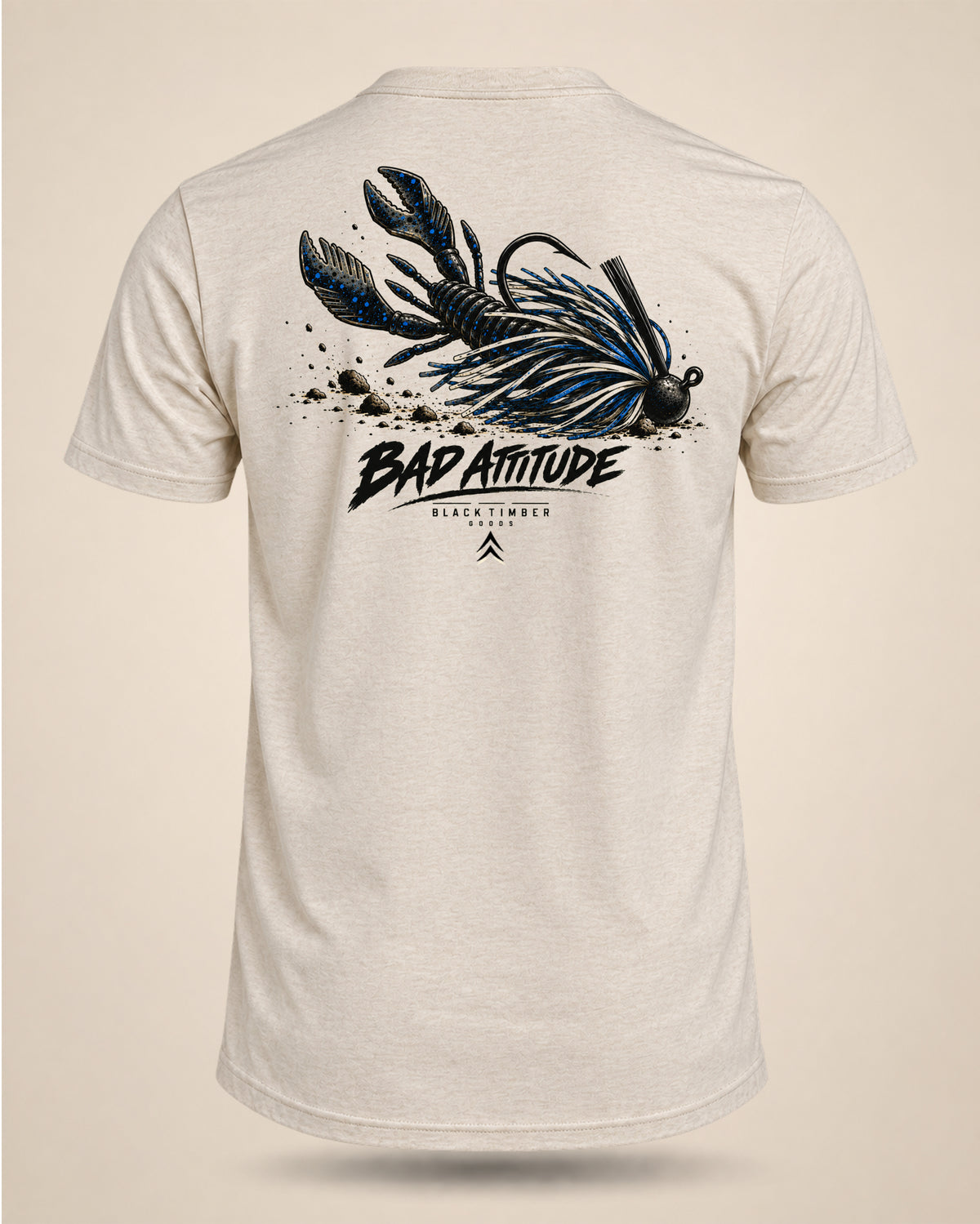 Cream Bad Attitude bass fishing T-shirt featuring a black and blue jig-and-craw graphic on the back.