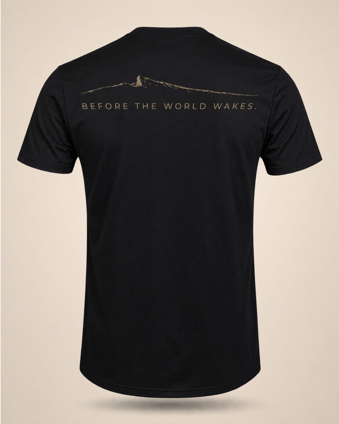 Black Before The World Wakes T-shirt featuring a minimalist dawn ridgeline graphic on the back.