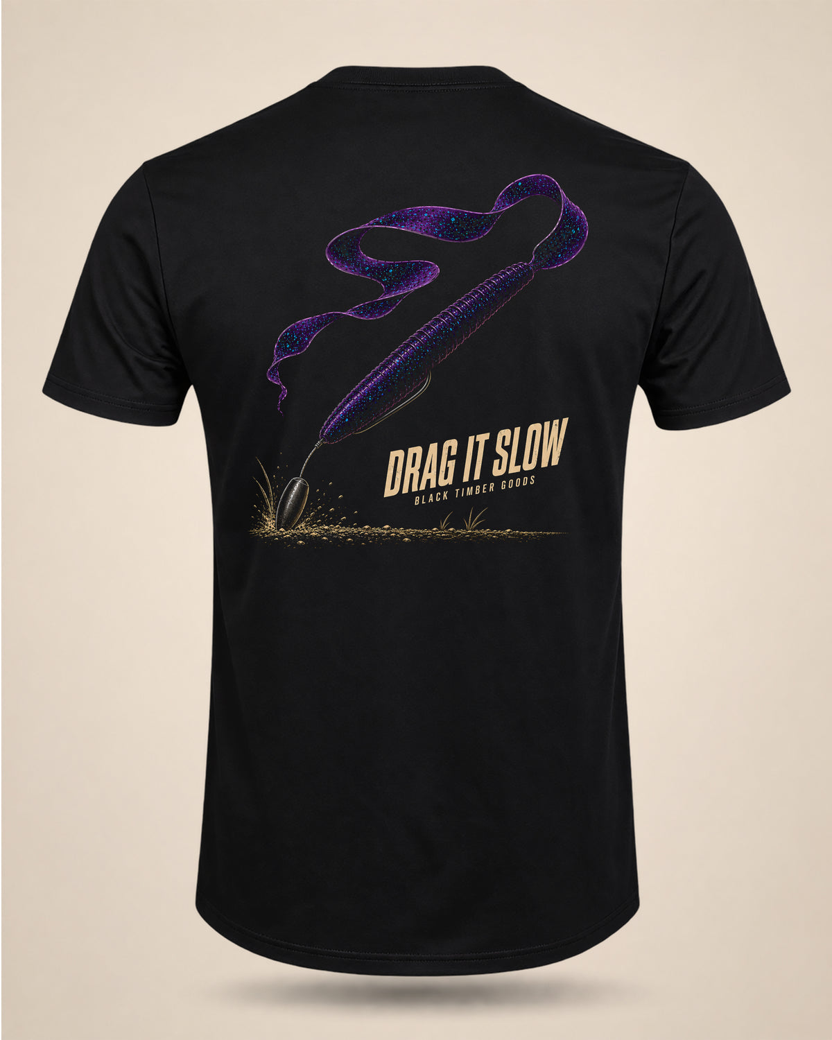 Black Drag It Slow bass-fishing T-shirt featuring a purple Texas-rigged ribbon-tail worm dragging along the bottom.