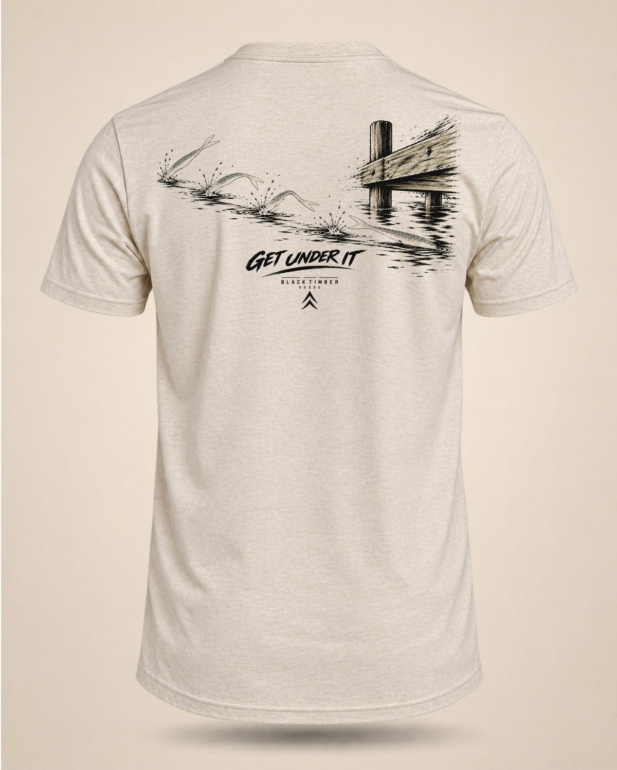 Cream Get Under It bass fishing T-shirt featuring baitfish skipping across the surface near a dock graphic on the back.