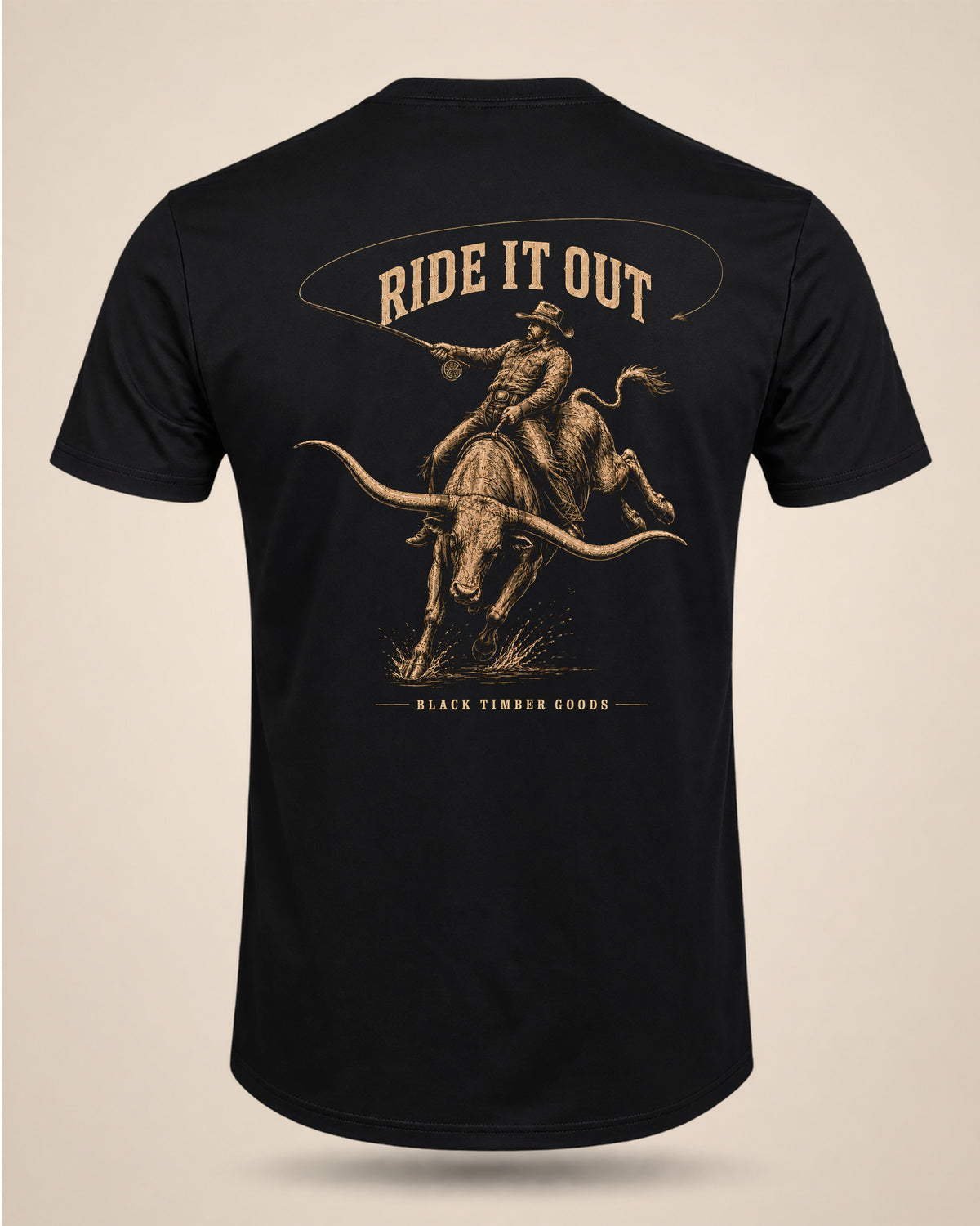 Black Ride It Out T-shirt featuring a cowboy casting a fly rod while riding a bucking longhorn.