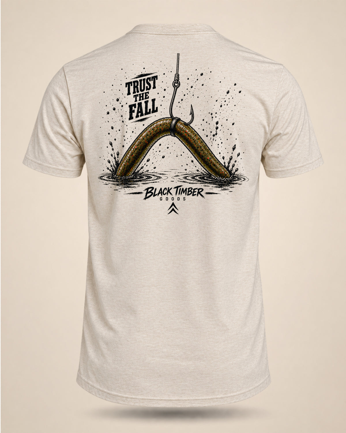 Cream Trust The Fall bass fishing T-shirt featuring a wacky-rigged worm falling into the water with splash details on the back.