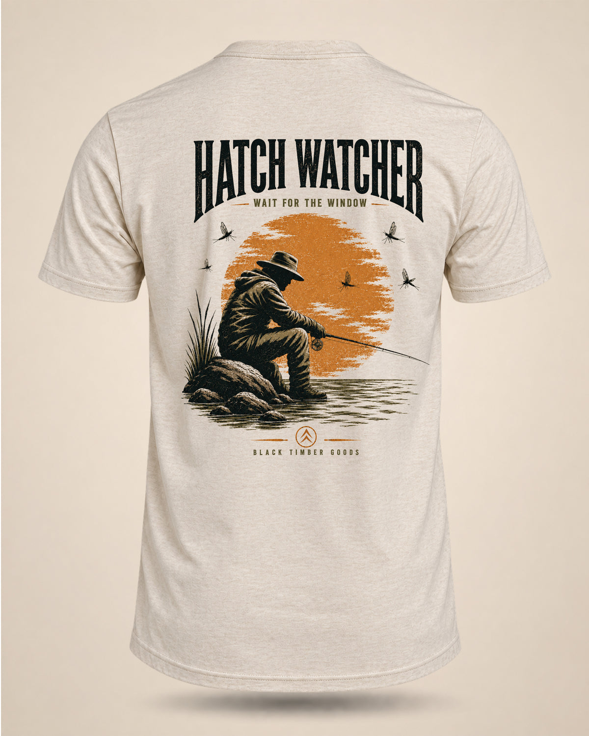 Cream Hatch Watcher fly-fishing T-shirt featuring a seated angler surrounded by mayflies with the text Wait For The Window.