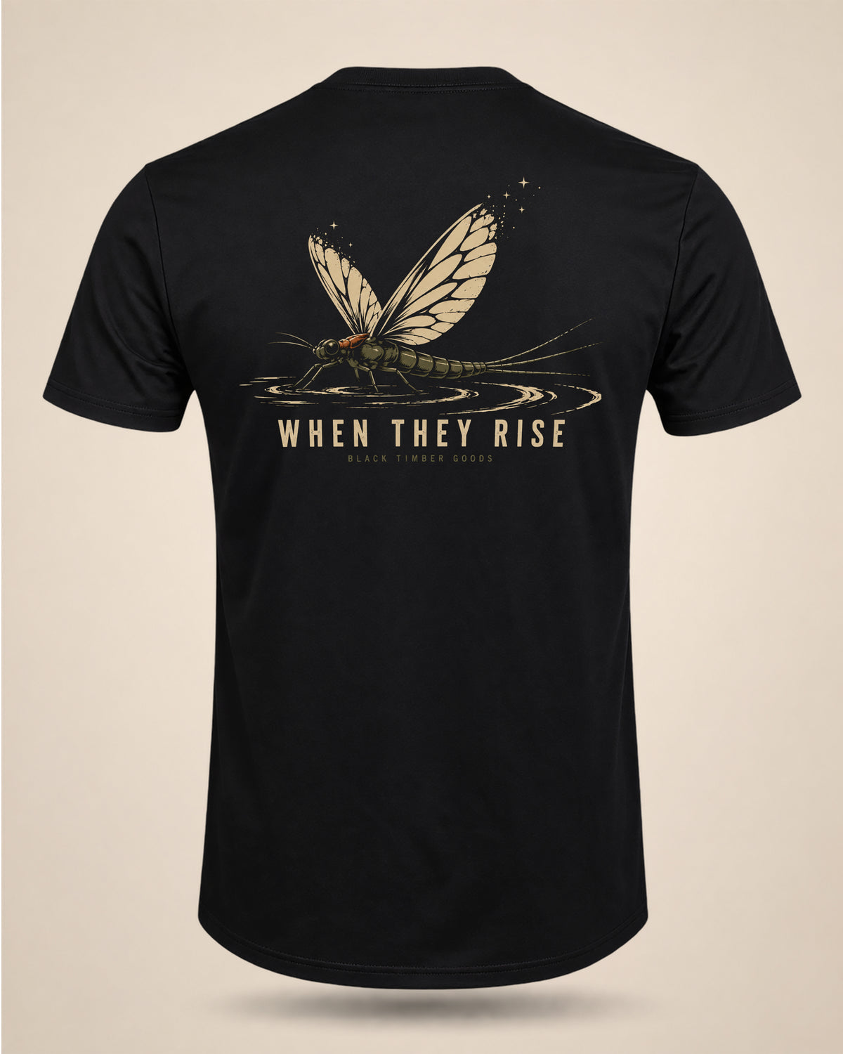Black When They Rise fly-fishing graphic T-shirt featuring a large mayfly over the water with subtle hatch detail.