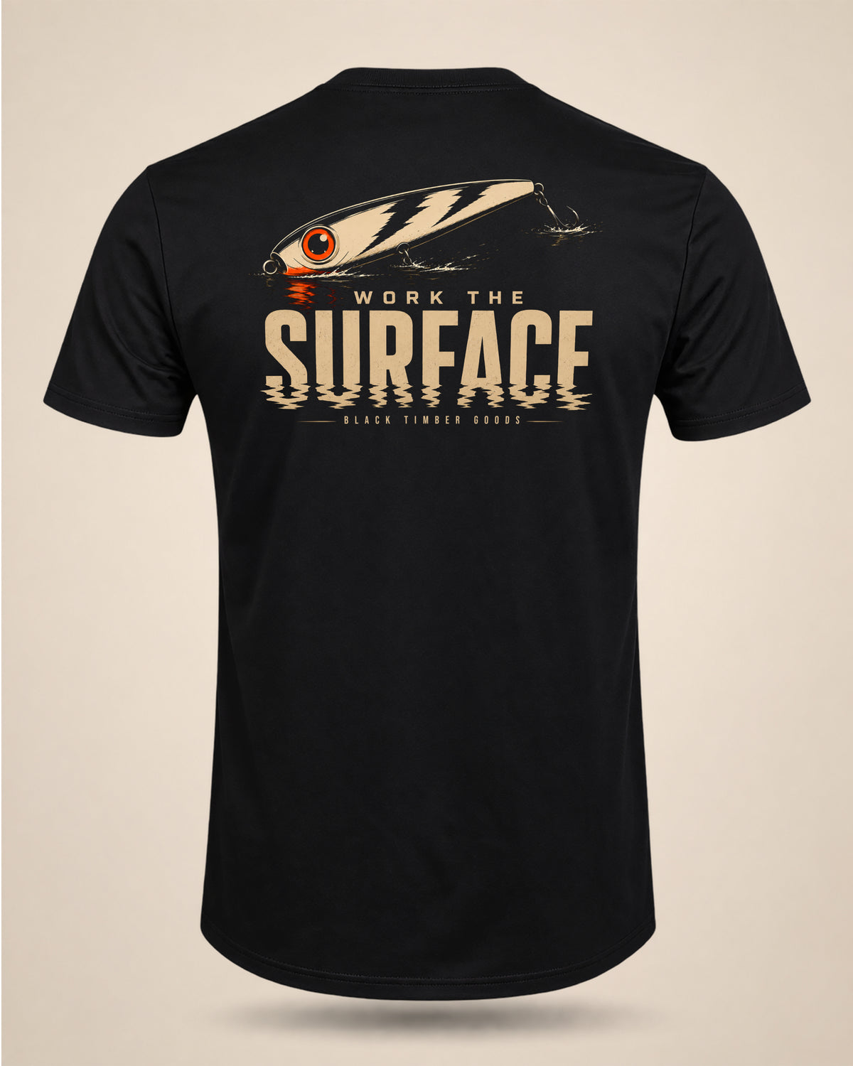 Black Work The Surface T-shirt featuring a topwater lure graphic and cream typography on the back.