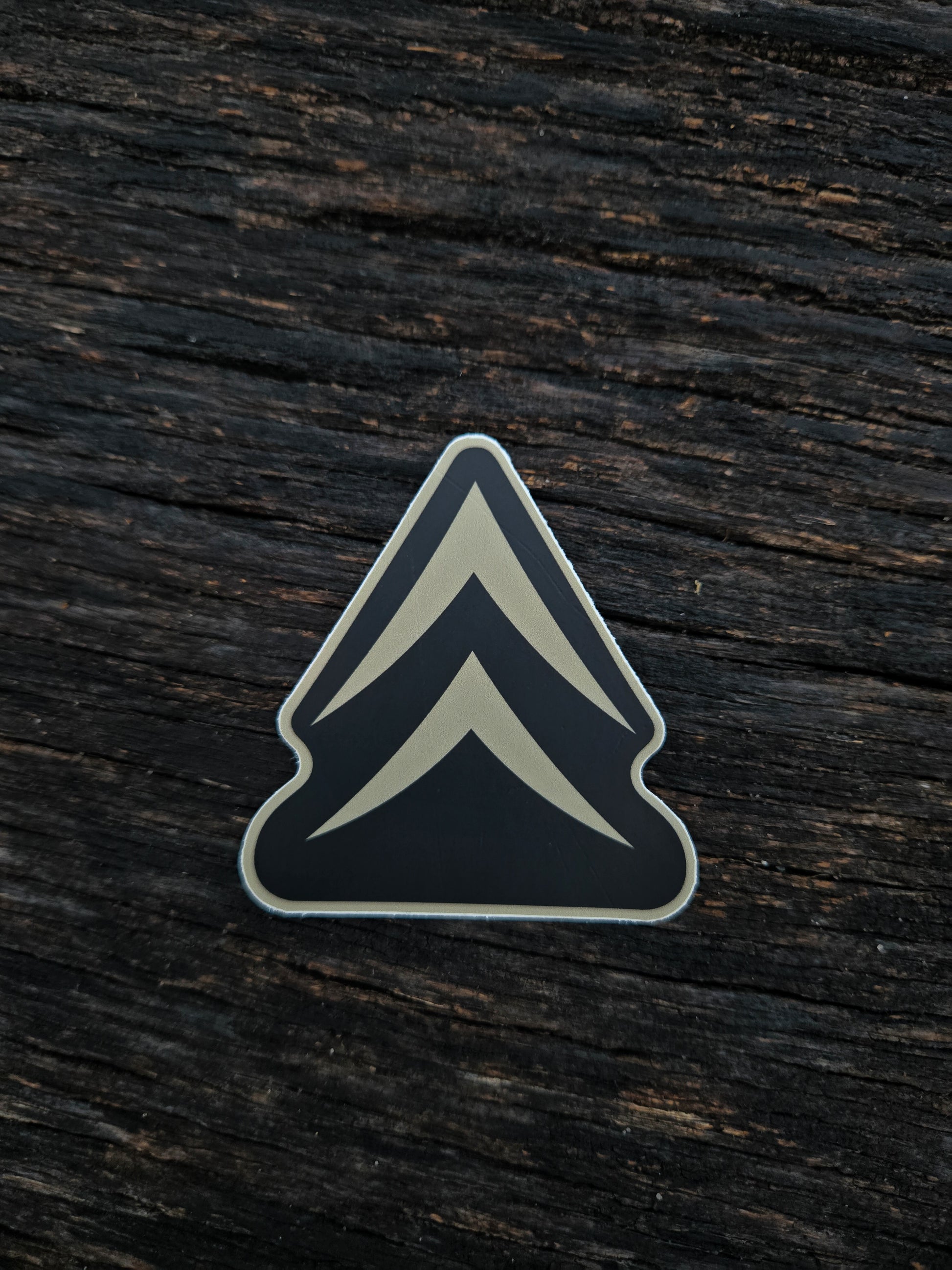 Alpine Chevron waterproof vinyl sticker by Black Timber Goods on weathered wood.