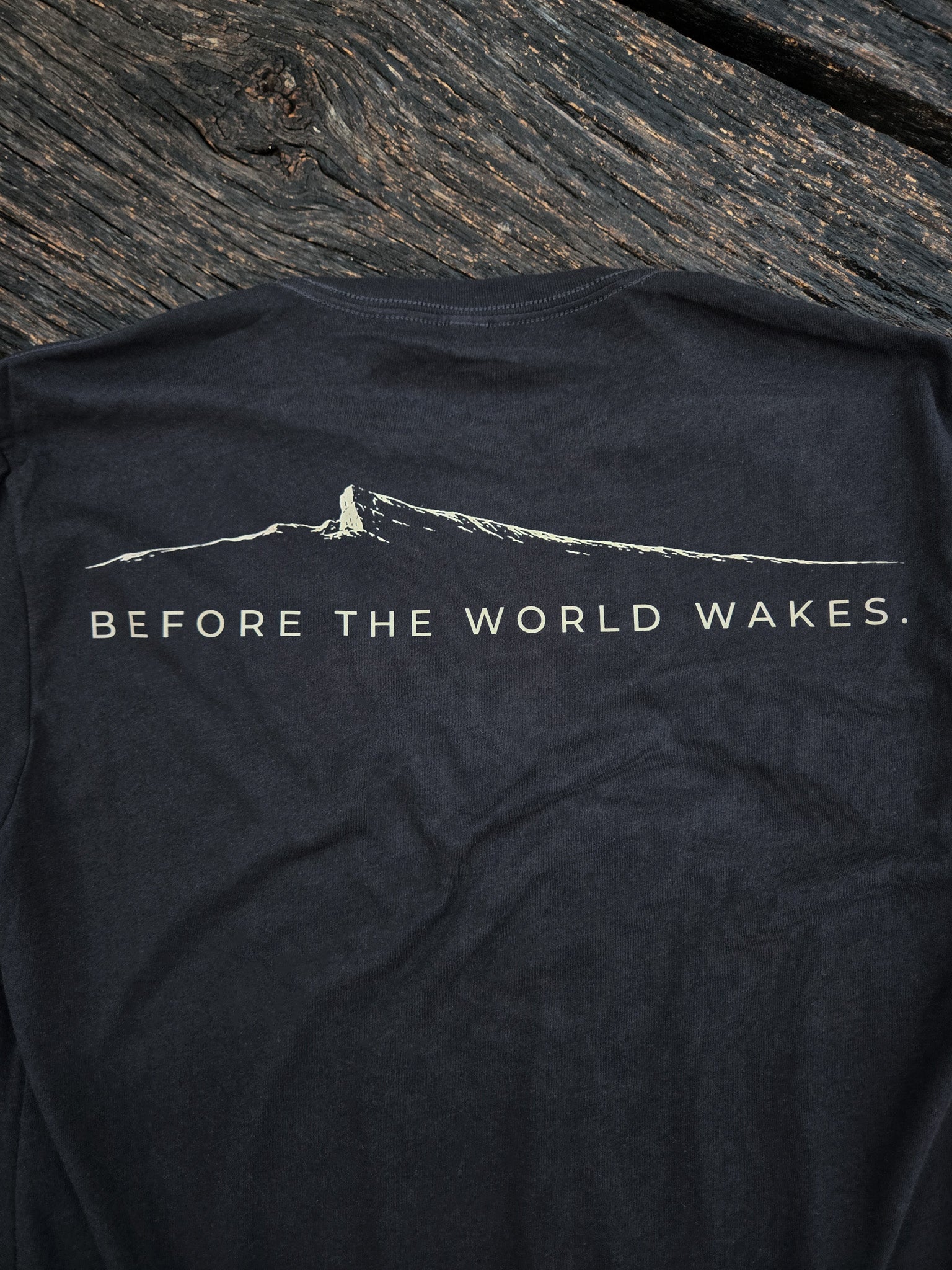 Back graphic of the Before The World Wakes outdoor shirt by Black Timber Goods.