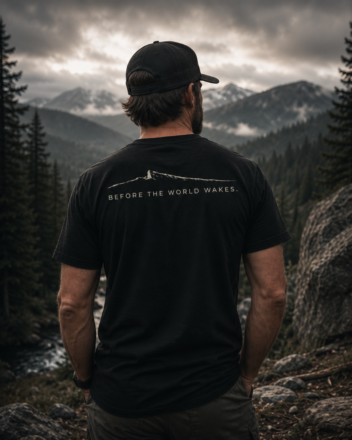 Person wearing the Before The World Wakes outdoor shirt by Black Timber Goods on a mountain overlook.
