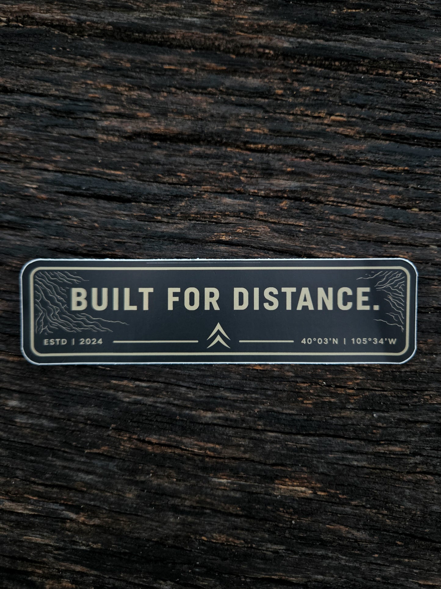 Built For Distance waterproof vinyl sticker by Black Timber Goods on weathered wood.