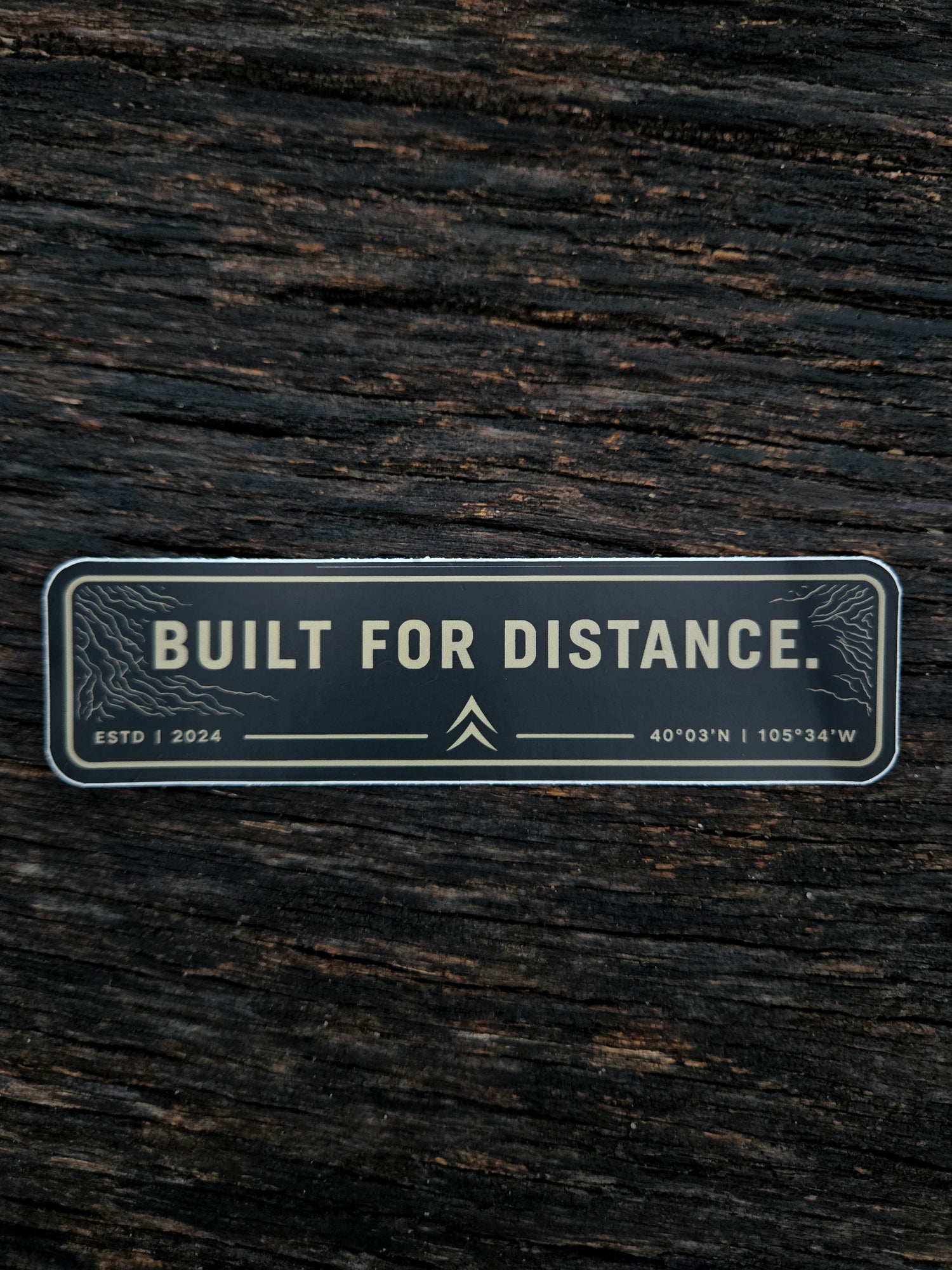 Built For Distance waterproof vinyl sticker by Black Timber Goods on weathered wood.