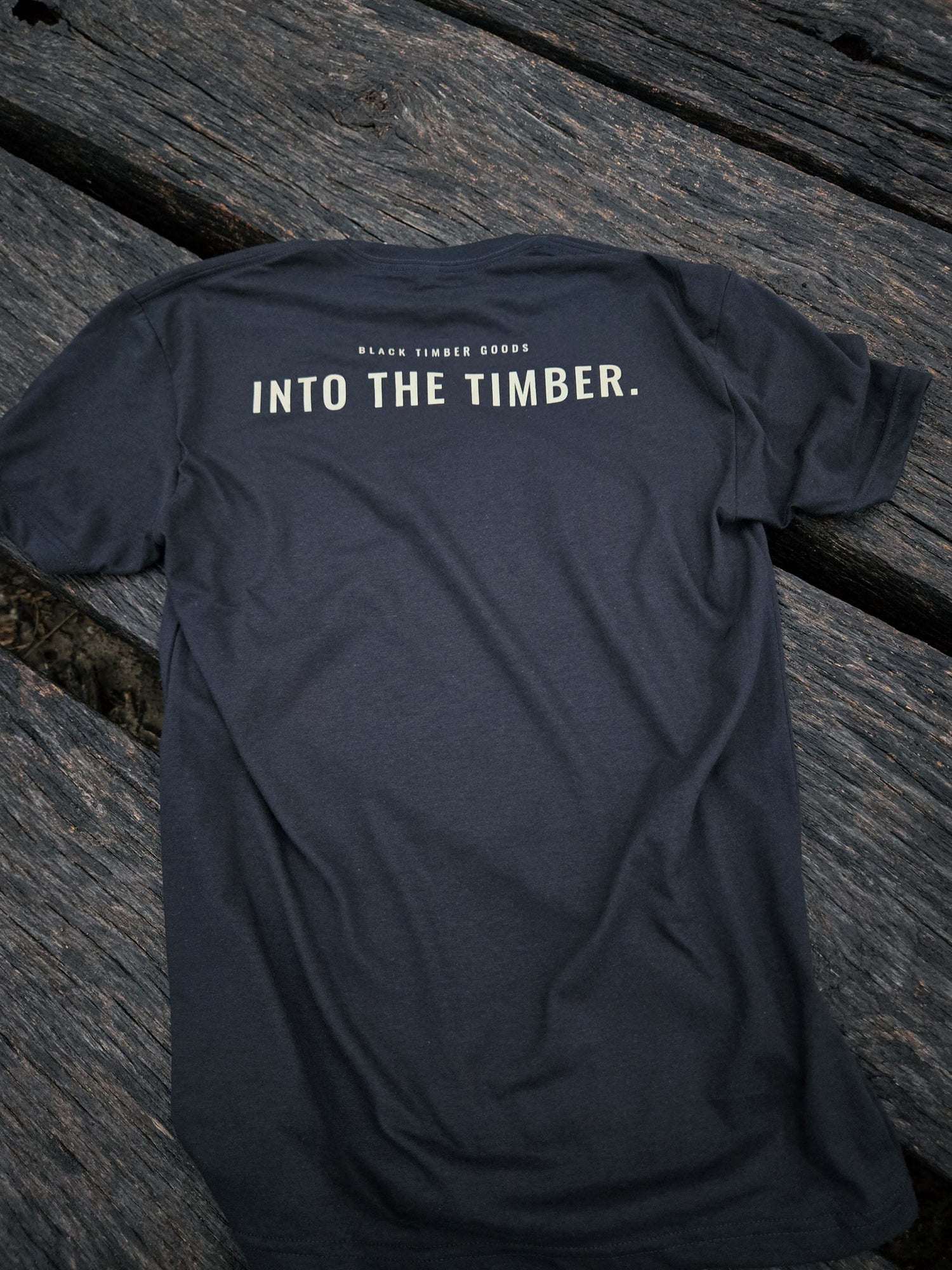Back of Into The Timber trail shirt by Black Timber Goods featuring minimalist typography.