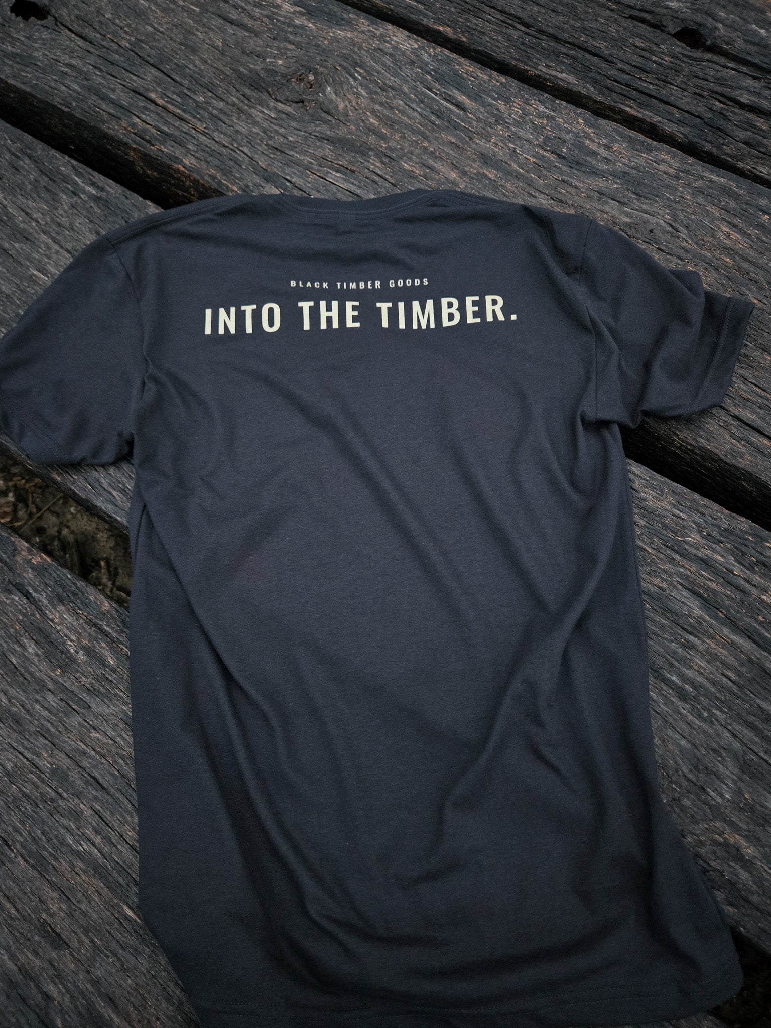 Back of Into The Timber trail shirt by Black Timber Goods featuring minimalist typography.