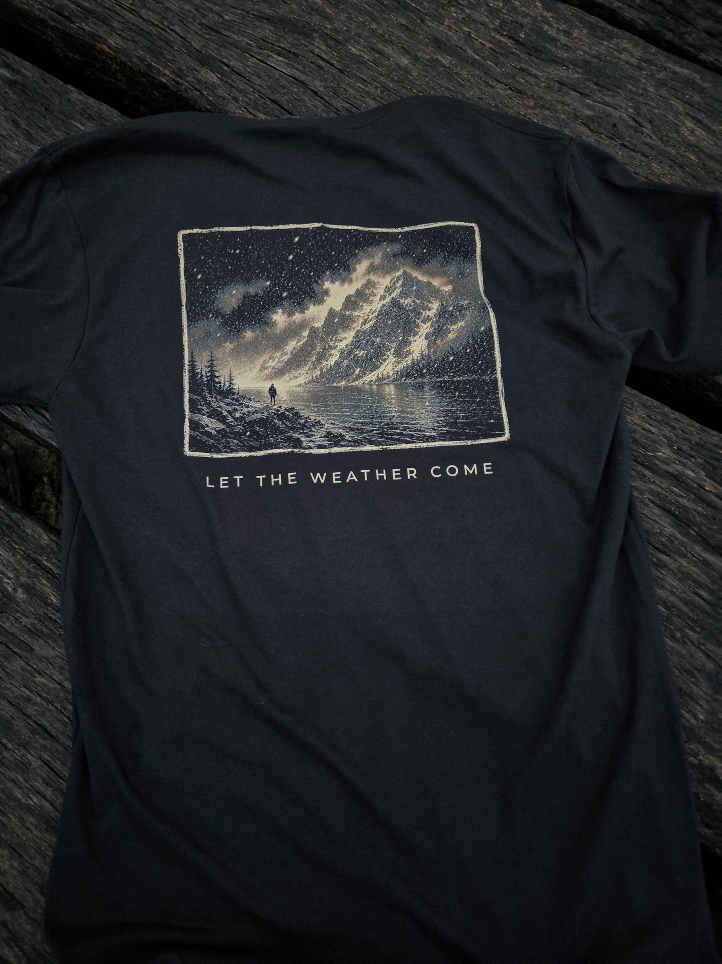 Back of Let The Weather Come weather shirt by Black Timber Goods featuring a mountain storm graphic.
