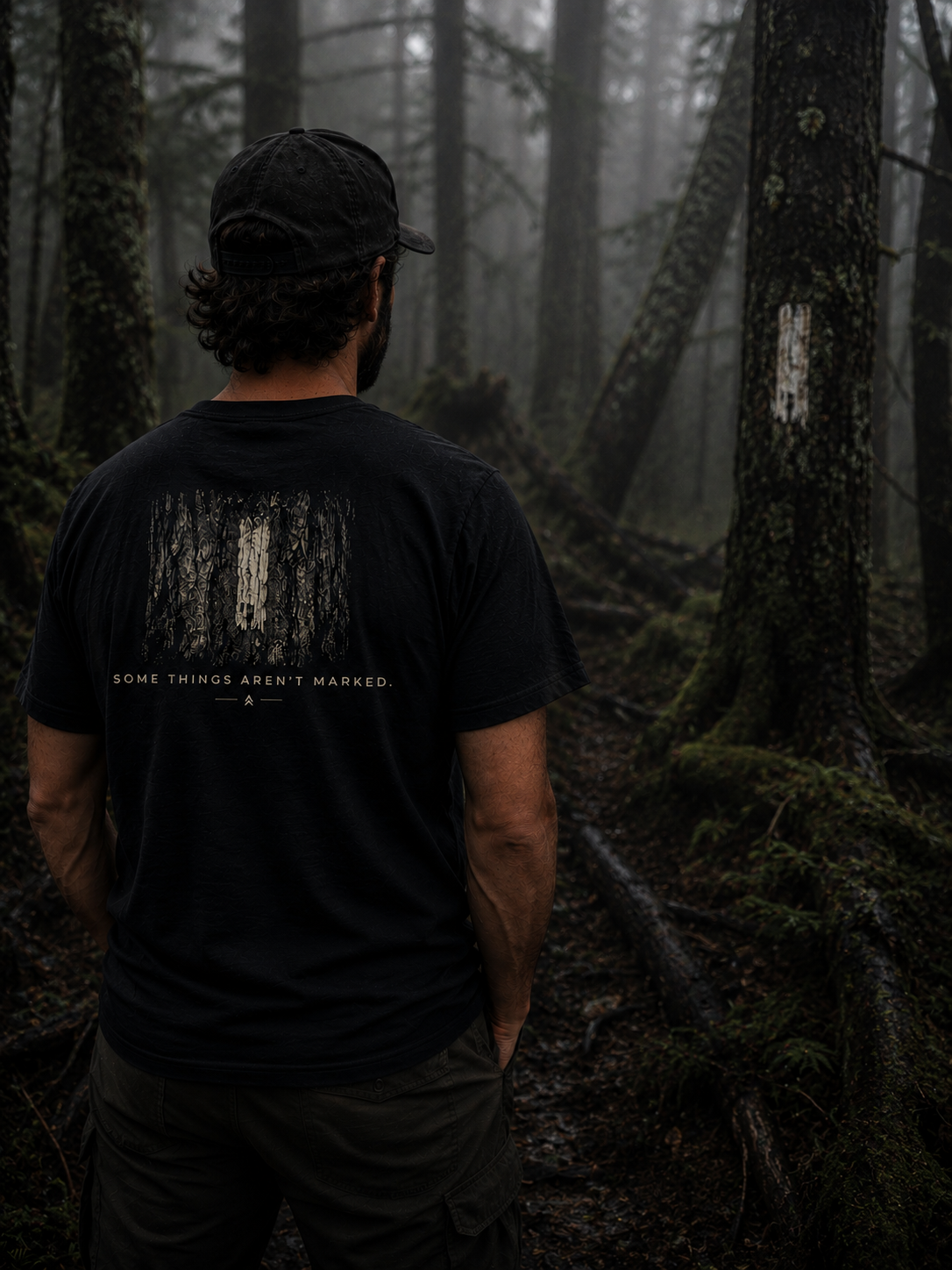 Person wearing Some Things Aren't Marked trail blaze shirt by Black Timber Goods on a forest trail.