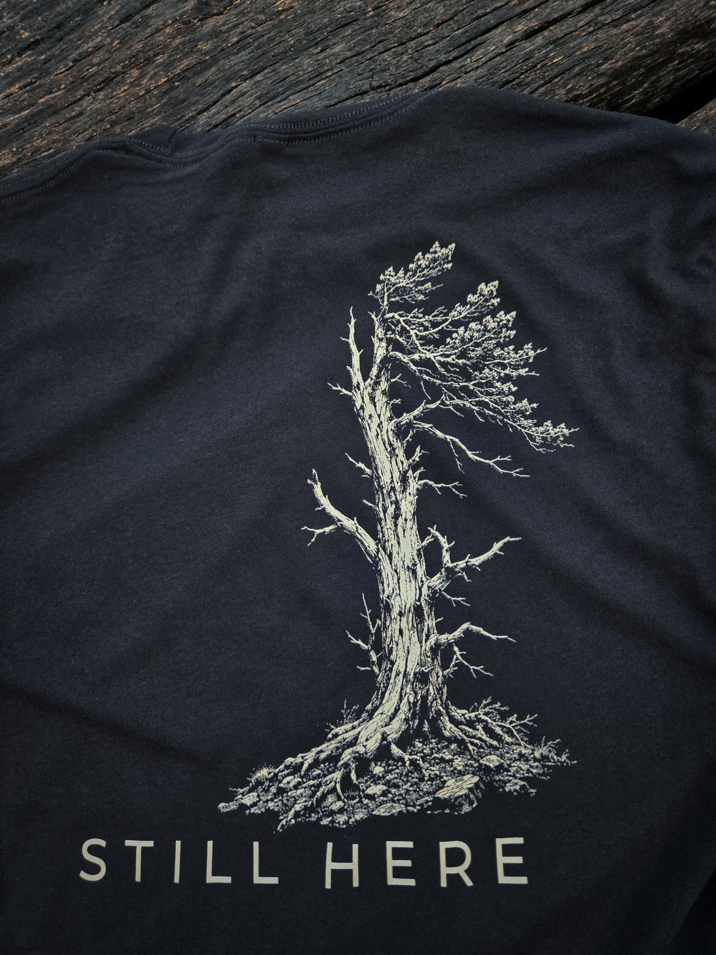 Close-up of the Still Standing weather tree artwork on the back of the shirt.