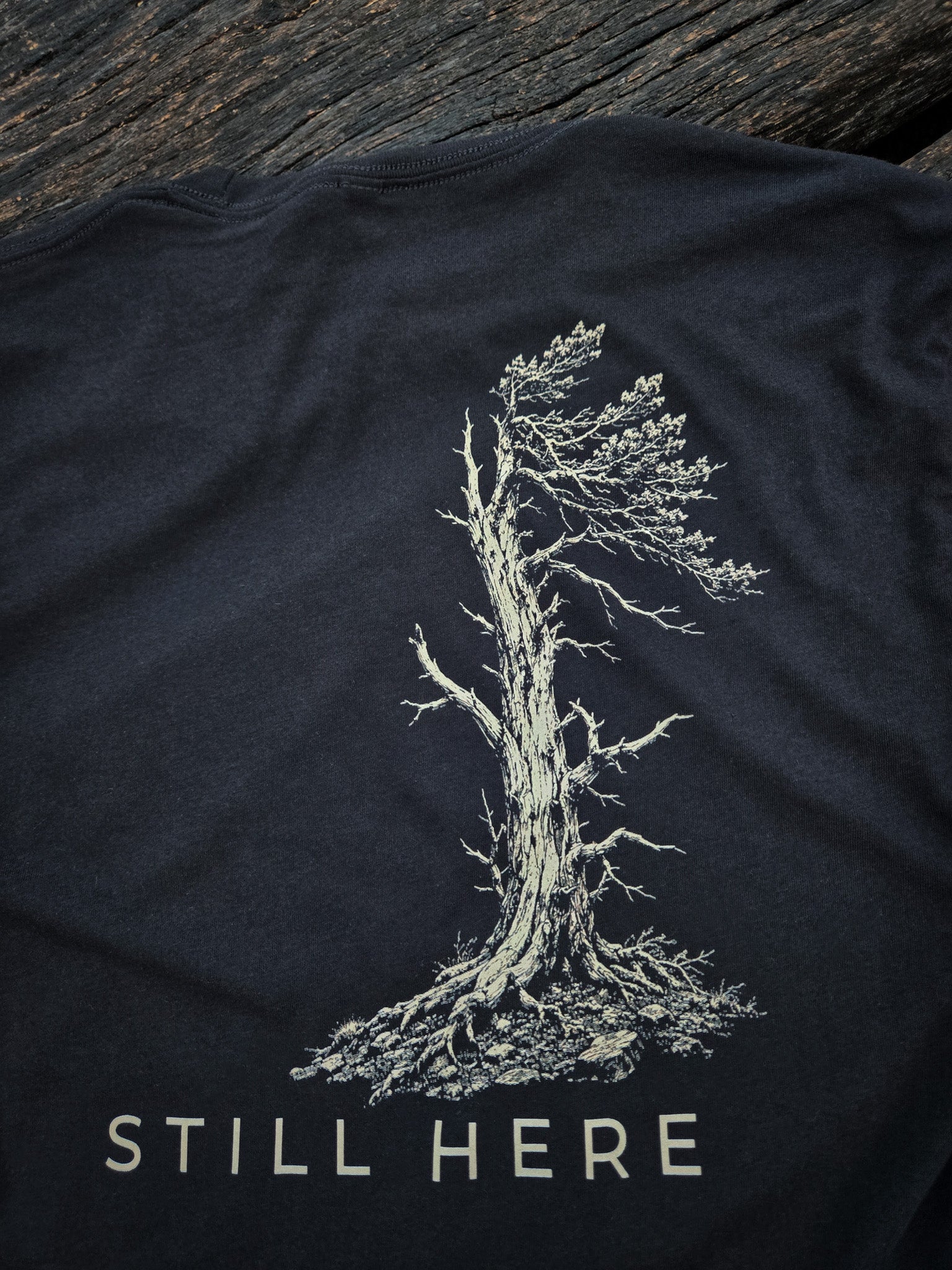 Close-up of the Still Standing weather tree artwork on the back of the shirt.