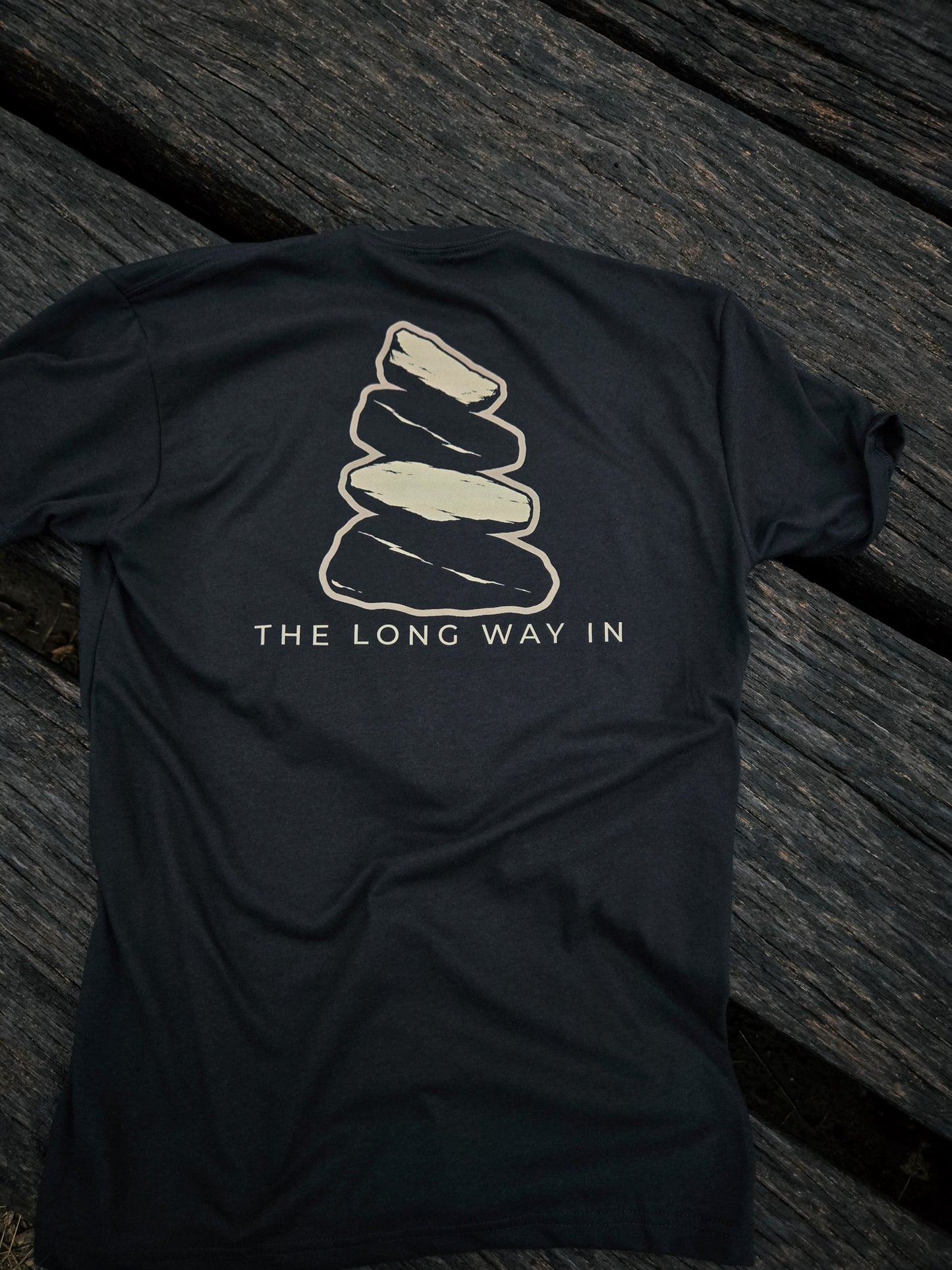 Back of The Long Way In cairn shirt by Black Timber Goods featuring a weathered stone cairn graphic.