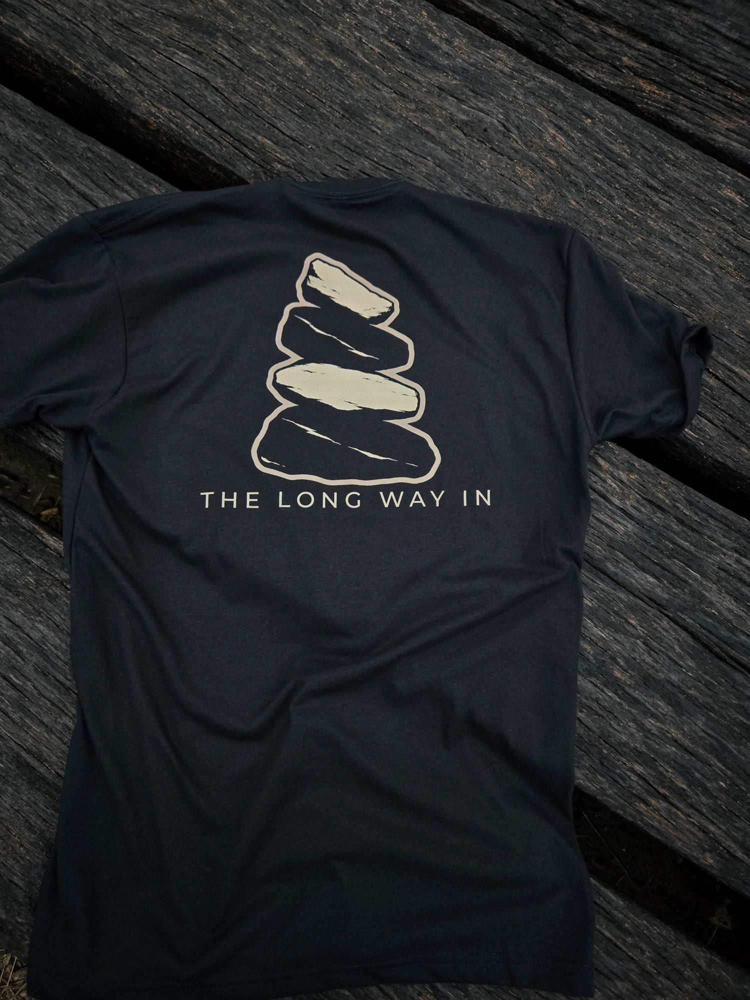 Back of The Long Way In cairn shirt by Black Timber Goods featuring a weathered stone cairn graphic.