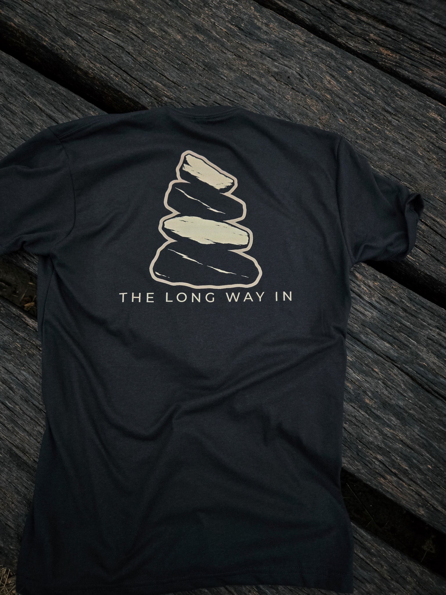 Back of The Long Way In cairn shirt by Black Timber Goods featuring a weathered stone cairn graphic.