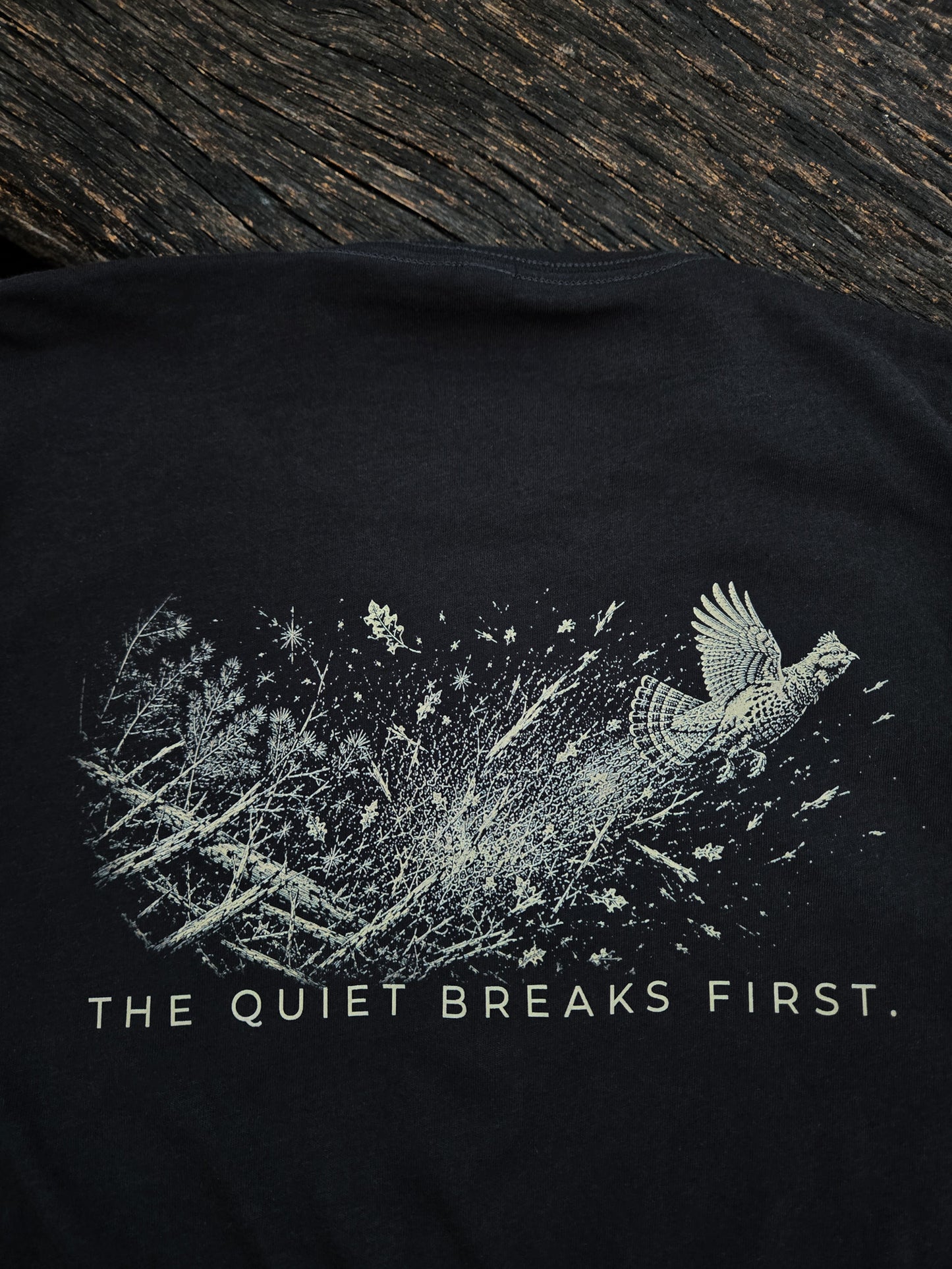 Close-up of The Quiet Breaks First grouse artwork on the back of the shirt.