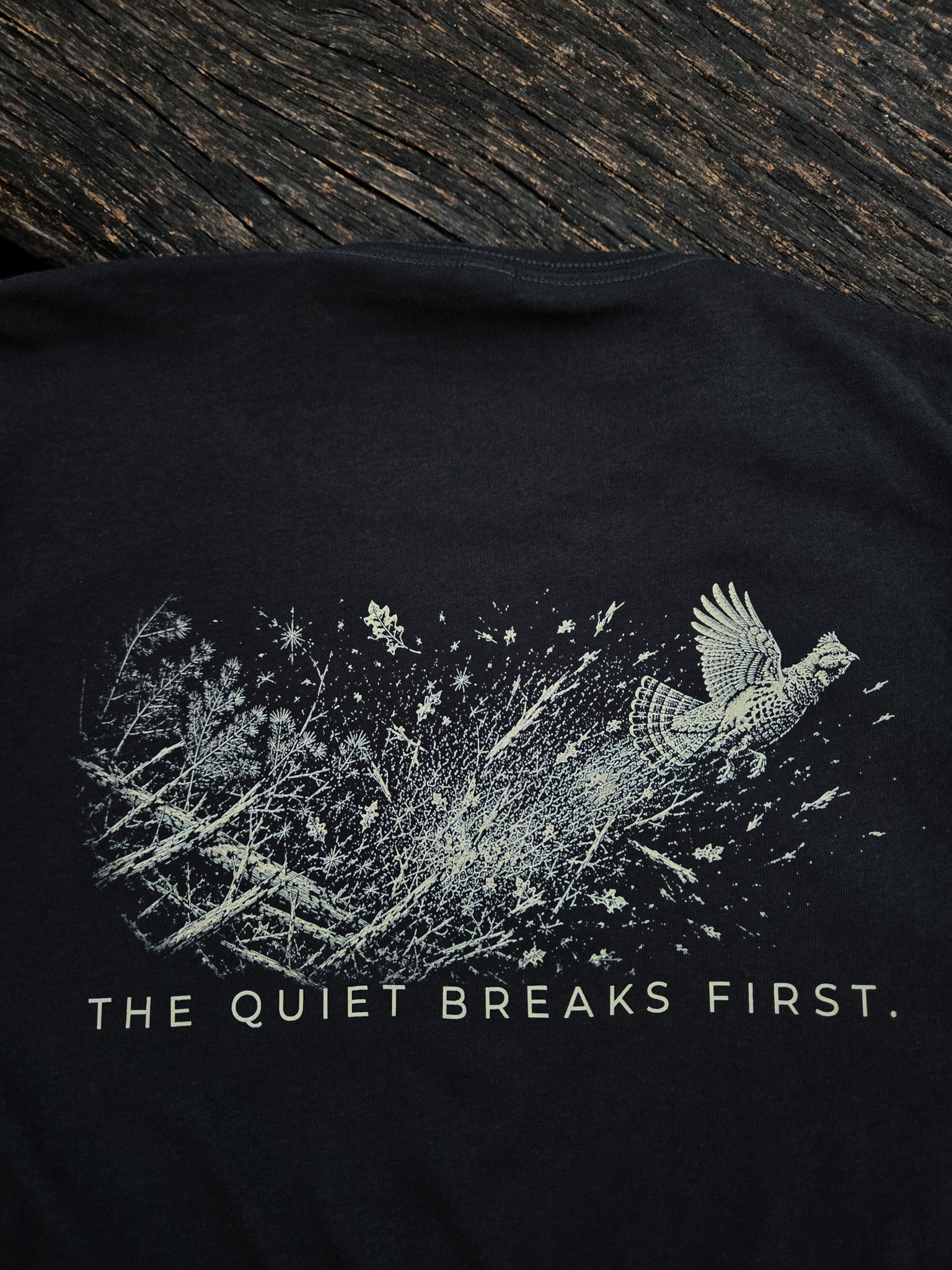 Close-up of The Quiet Breaks First grouse artwork on the back of the shirt.