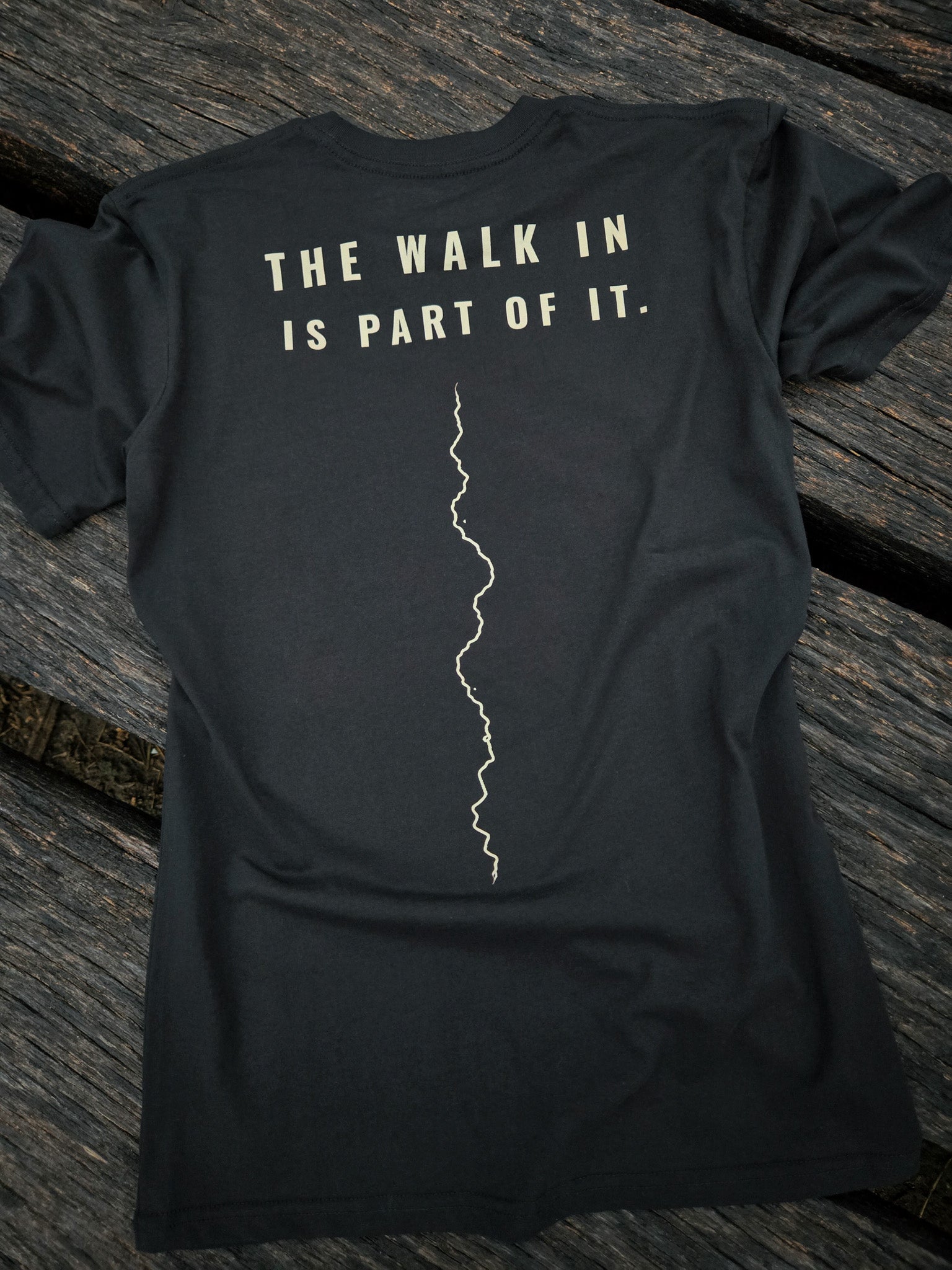 Back of The Walk In Is Part Of It trail shirt by Black Timber Goods featuring a minimalist trail graphic.