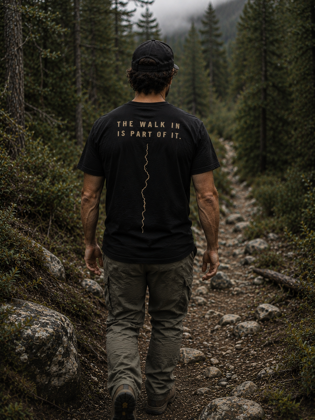 Person wearing The Walk In Is Part Of It trail shirt by Black Timber Goods on a wooded trail.