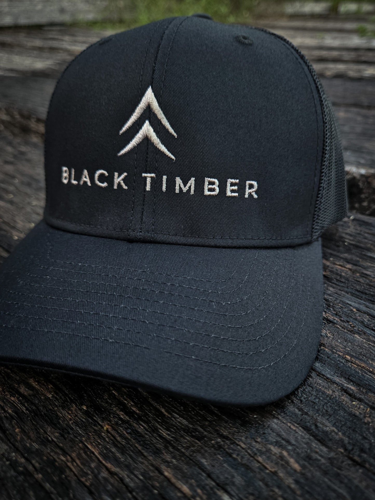 Front of the Timber Mark Richardson 112 trucker hat by Black Timber Goods in black with tonal embroidery.