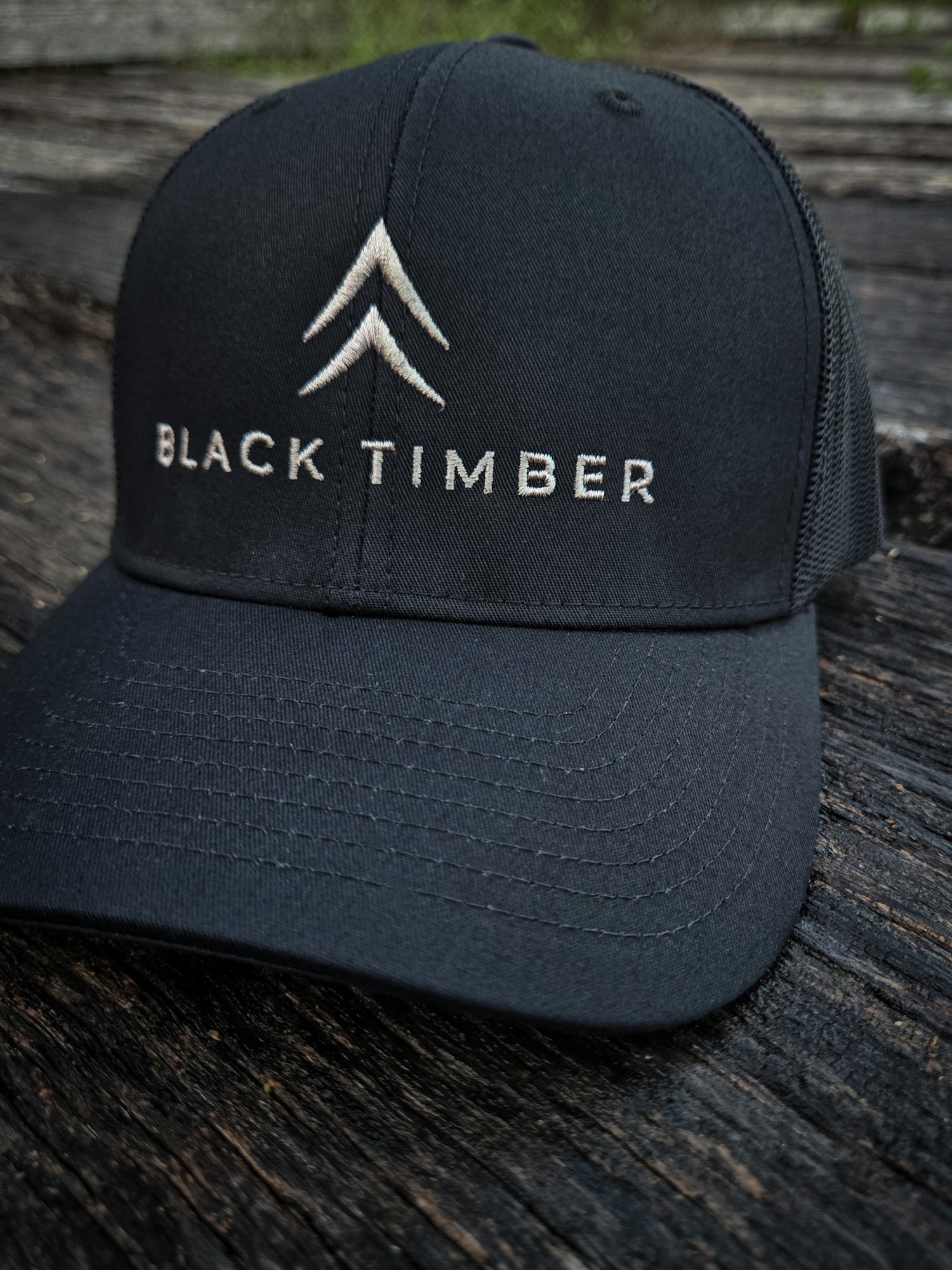Front of the Timber Mark Richardson 112 trucker hat by Black Timber Goods in black with tonal embroidery.